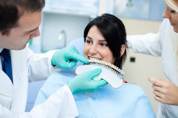 woman picking out tooth whitening shade | teeth whitening farmington hills mi
