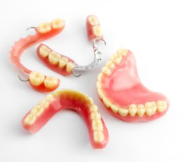 close up of single denture piece | dentist farmington hills mi