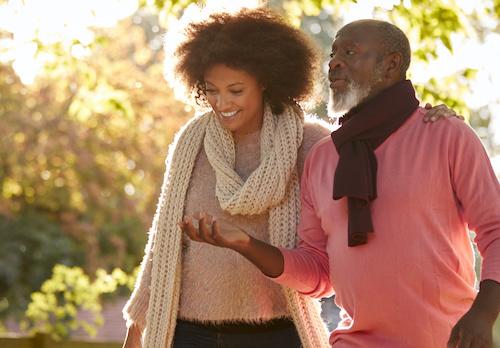 young couple walking with scarves | dental implants farmington hills mi