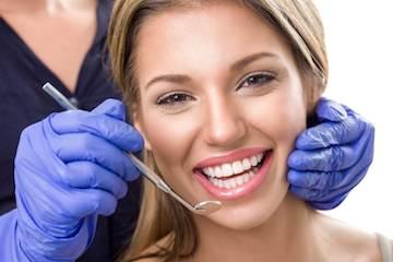 woman receiving dentist exam | farmington hills mi dentist