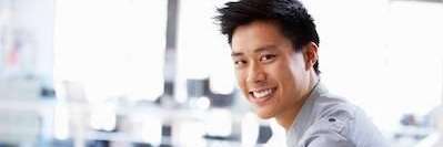 man smiling while sitting in an office