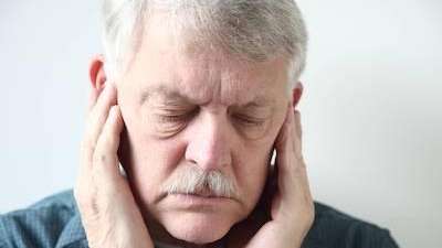 man in pain holding jaw | periodontal disease treatment farmington hills mi
