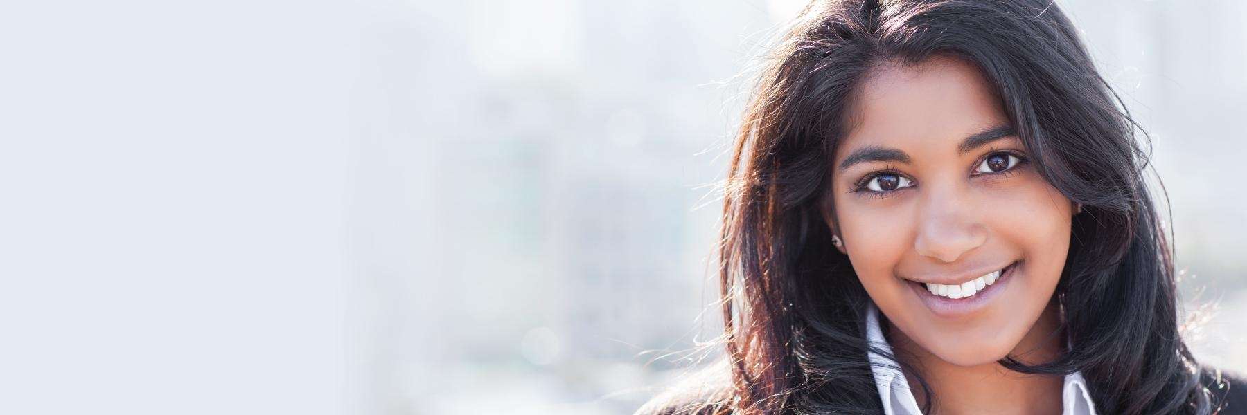 woman with black hair smiling | periodontal disease treatment farmington hills mi